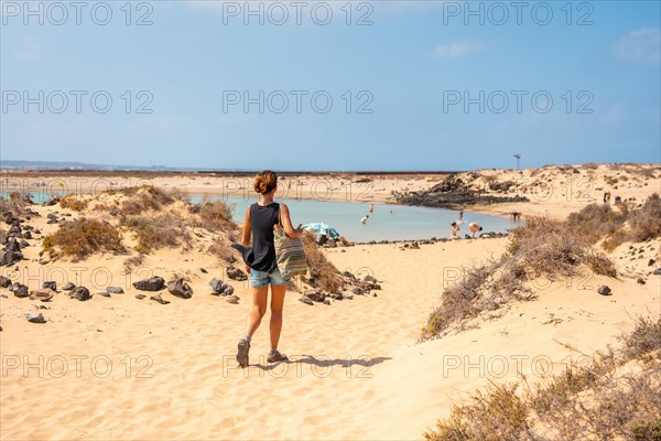 A young tourist visiting La Concha beach on Isla de Lobos