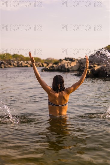 A young tourist bathing in the water of a Nubian village on the river Nile and near the city of Aswan. Egypt