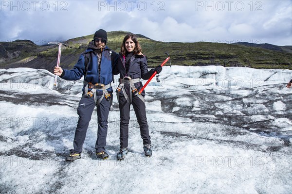 A couple of tourists on the ice of the Svinafellsjokull glacier. Iceland