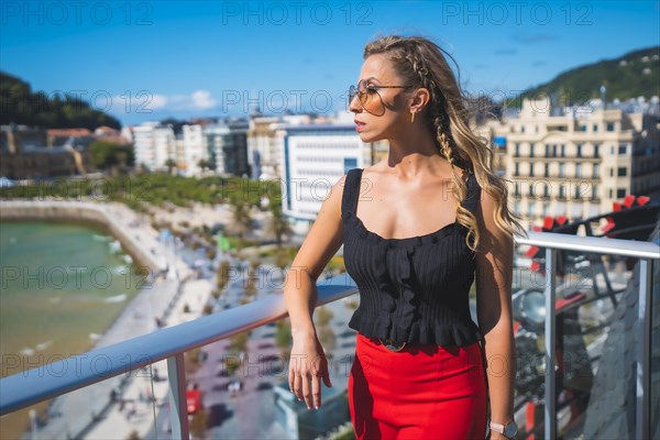 Blonde woman spending holidays in a luxury hotel on a terrace