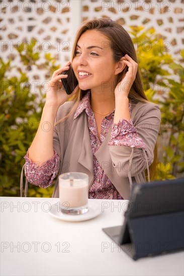 Executive blonde woman or businesswoman having a decaf coffee breakfast and looking at the email