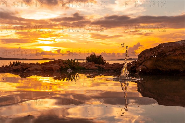 Drops of water after the throwing of a stone at sunset in San Antonio Abad