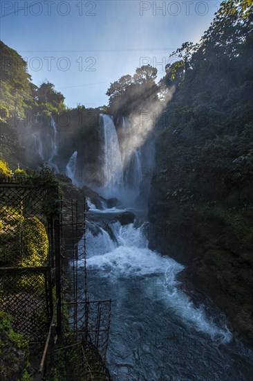 Flashes of the sun at dawn inside the Pulhapanzak waterfall on Lake Yojoa. Honduras