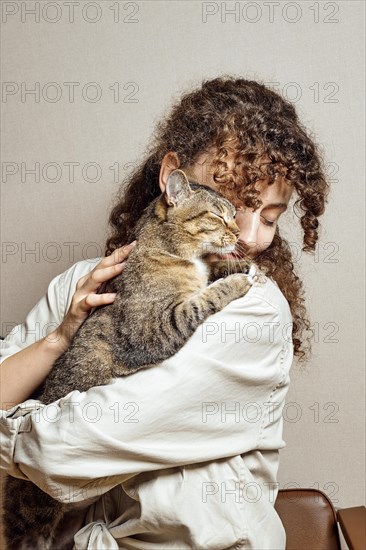 A devoted and gentle cat hugs his happy owner