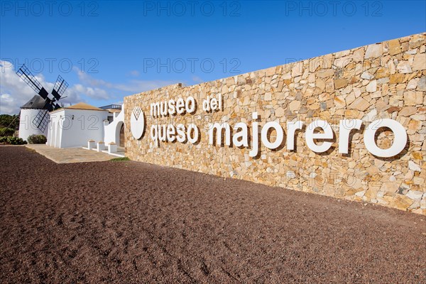 View of quarry stone wall with lettering Logo Museo del Queso Majorero Cheese Museum Majorero Cheese