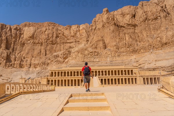 A young woman visiting the Mortuary Temple of Hatshepsut without people on her return from tourism in Luxor after the coronavirua pandemic