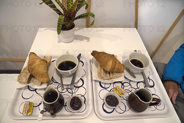 Typical French breakfast brioche and coffee in a budget hotel