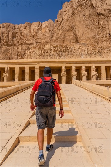 A young woman on the entrance stairs to the Funerary Temple of Hatshepsut in Luxor. Egypt