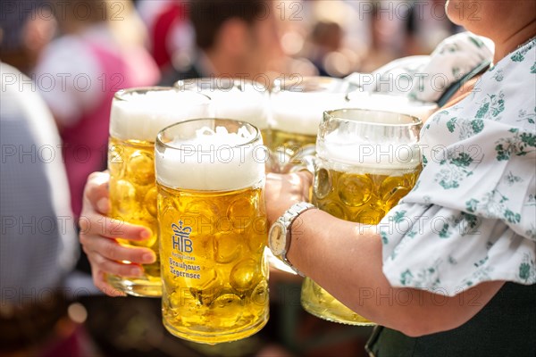 Waiter with beer mugs