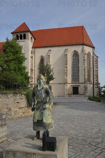 Late Gothic collegiate church with sculpture of medieval knight