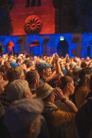 Cheering crowd at Live Klostersommer Festival in Historic Monastery