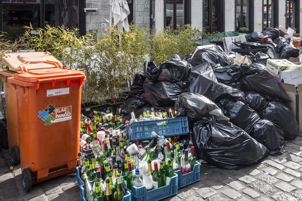 Rubbish bags and garbage containers with piled up household refuse due to strike by waste processing firm