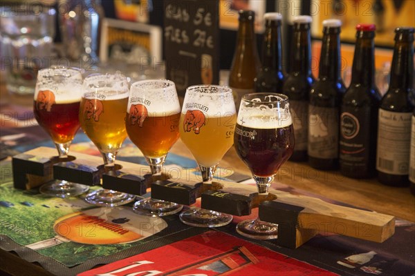 Beer sampler plank with Belgian beers for beer tasting in Flemish cafe