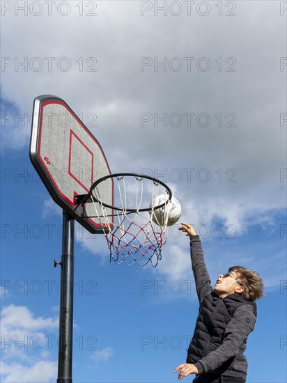 Basketball jumping with the ball to the basket and net