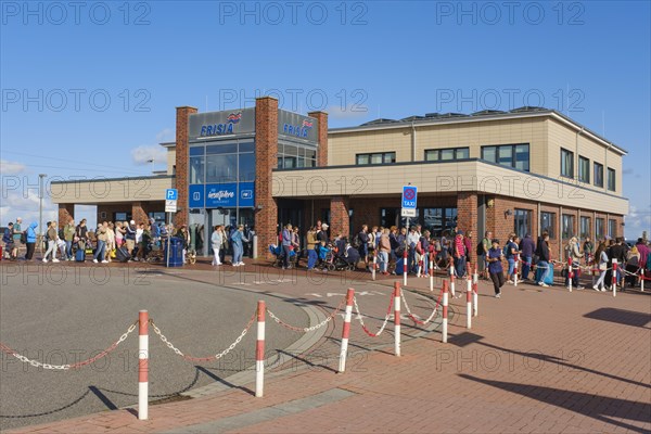 People waiting in line at the terminal for the island ferry Norderney