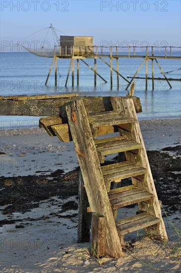 Traditional carrelet fishing hut with lift net on the beach