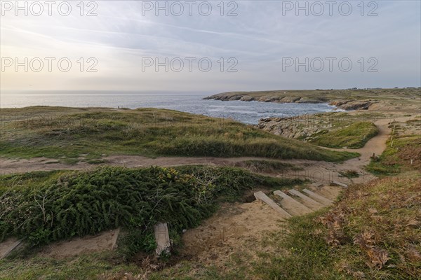 Hiking trail on the Cote Sauvage. The Wild Coast is a rocky coast on the west side of the Quiberon Peninsula in Brittany. Cores