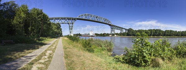 Kiel Canal with Hochdonn railway bridge and container ship