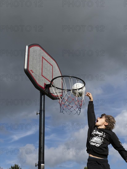 Basketball jumping with the ball to the basket and net