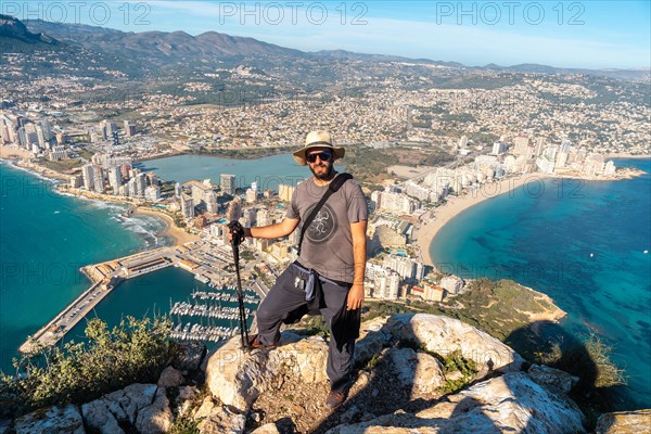 A young hiker at the top of the Penon de Ifach Natural Park in Calpe