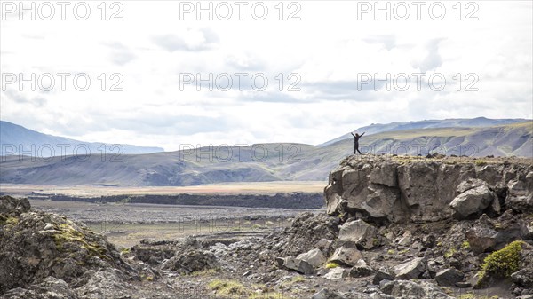 A young woman on top of a mound on the 4-day trek from Landmannalaugar. Iceland