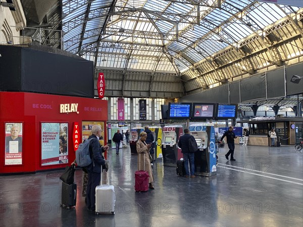 Travellers waiting in front of ticket counter