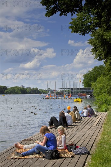 Tourists sunbathing along the Maschsee