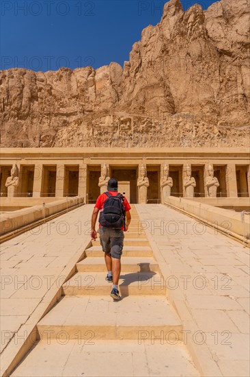 A young woman on the entrance stairs to the Funerary Temple of Hatshepsut in Luxor. Egypt