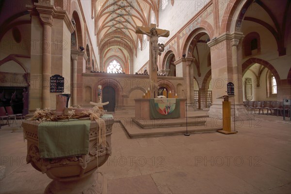 Interior view with baptismal font and crucifix of the monastery church and former Cistercian abbey