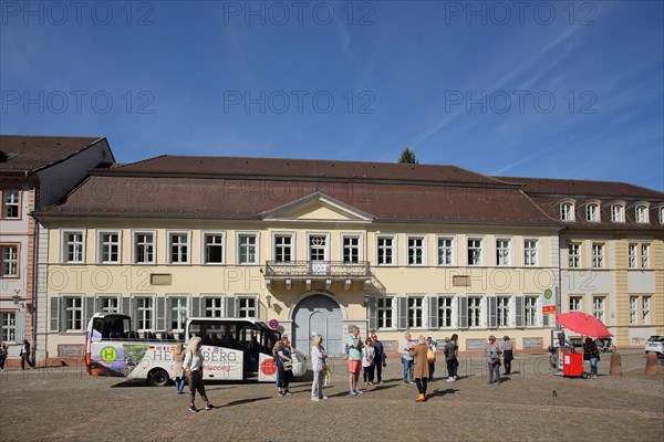 Tourists on sightseeing tour by bus in front of the university building