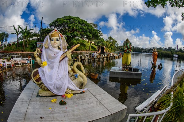 Left Goddess of Wisdom Sarasvati Saraswati Maa Wife Consort of Lord Brahma middle God Deity in Elephant Shape Shape of Elephant Elephant God Ganesha right background Goddess Deity Parvati Wife Consort Shakti of Lord Shiva at religious site largest Hindu sanctuary sanctuary for religion Hinduism outside of India for devout Hindu Hindus