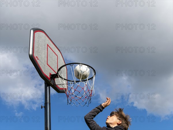 Basketball jumping with the ball to the basket and net