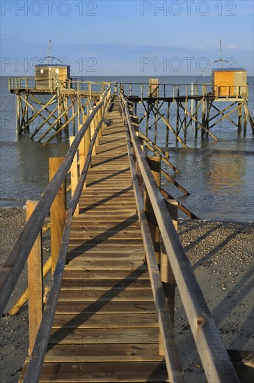 Traditional carrelet fishing huts with lift nets on the beach