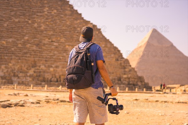 A young photographer at the pyramid of Cheops the largest pyramid. The pyramids of Giza the oldest funerary monument in the world. In the city of Cairo