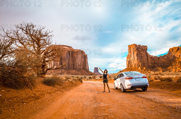 A female tourist driving through the interior of Monument Valley