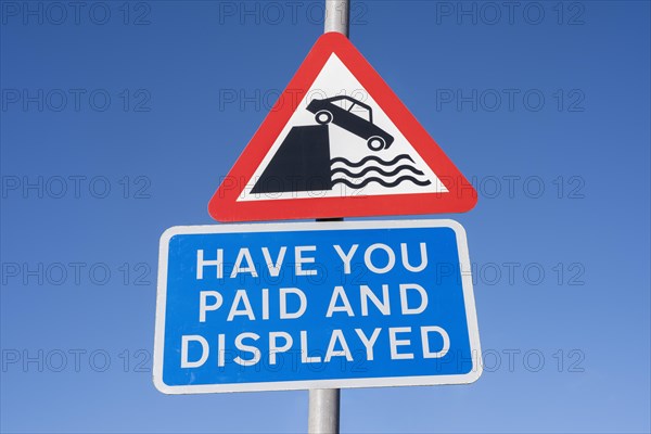 Traffic warning sign with pictogram Attention shore and English language sign for redeeming and visibly displaying a parking ticket