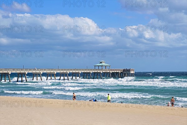 Stormy weather and pier in winter at Surfside Beach along the Atlantic Ocean in Miami-Dade County