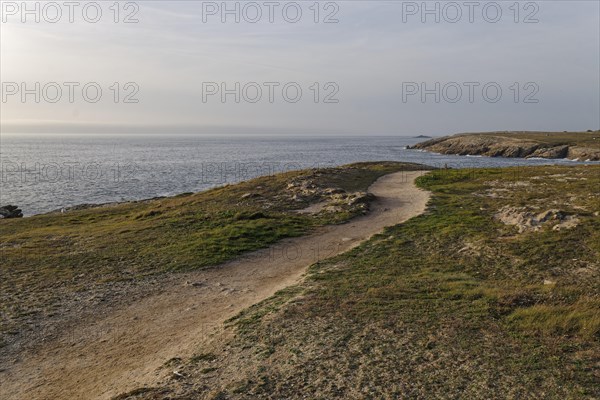 Hiking trail on the Cote Sauvage. The Wild Coast is a rocky coast on the west side of the Quiberon Peninsula in Brittany. Cores