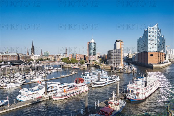View from a cruise ship of harbour cruise ships and the Niederhafen at the Ueberseebruecke of the Port of Hamburg