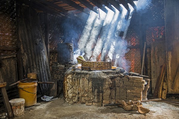 Primitive palm sugar factory boiling the collected sap near Pangandaran