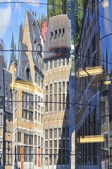 Reflection in glass facade of the historical buildings at the Cour des Mineurs