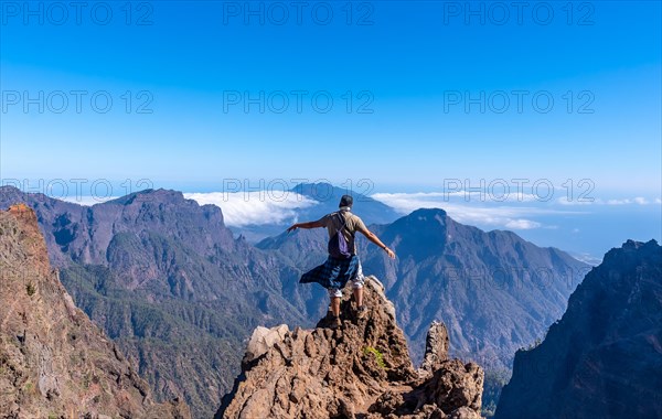 A young man after finishing the trek at the top of the volcano of Caldera de Taburiente near Roque de los Muchachos one summer afternoon