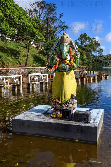Hindu god Hindu deity God figure Statue in elephant shape Shape of elephant Elephant god Ganesha stands on pedestal in Sacred lake religious site largest Hindu sanctuary Sanctuary for religion Hinduism outside India for devout Hindu Hindus