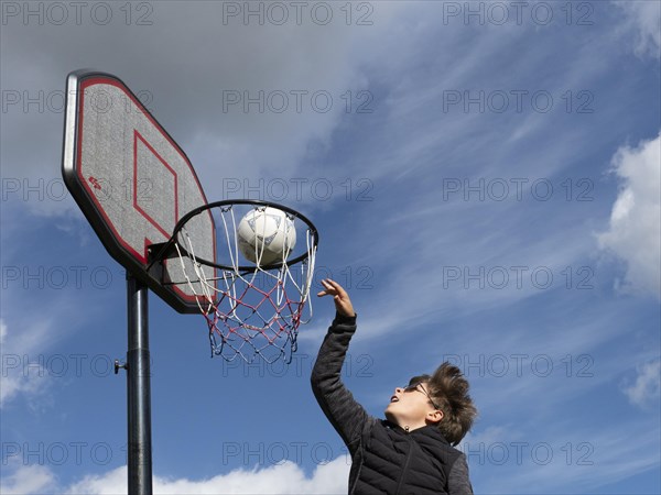 Basketball jumping with the ball to the basket and net