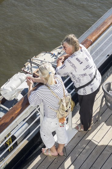 Passengers looking over the railing