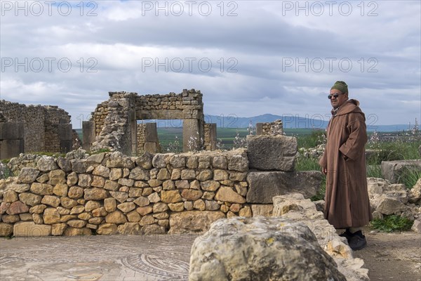 Man with djellab in the ruins of Volubilis