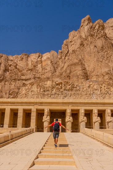 A young woman on the entrance stairs to the Funerary Temple of Hatshepsut in Luxor. Egypt