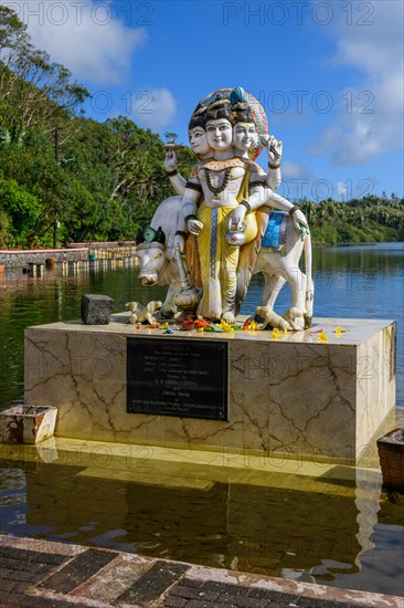 Hindu deity statue figure sculpture of god deity Dattatreya embodiment of trinity Brahma Vishnu Shiva at religious site largest Hindu sanctuary sanctuary for religion Hinduism outside of India for devout Hindu Hindus