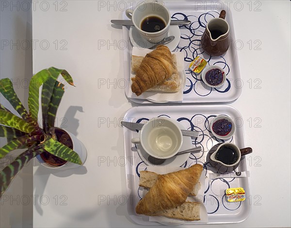 Typical French breakfast brioche and coffee in a budget hotel