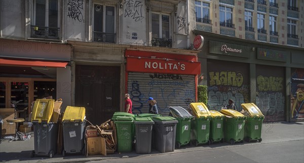 Full paper bins on the street ready for collection